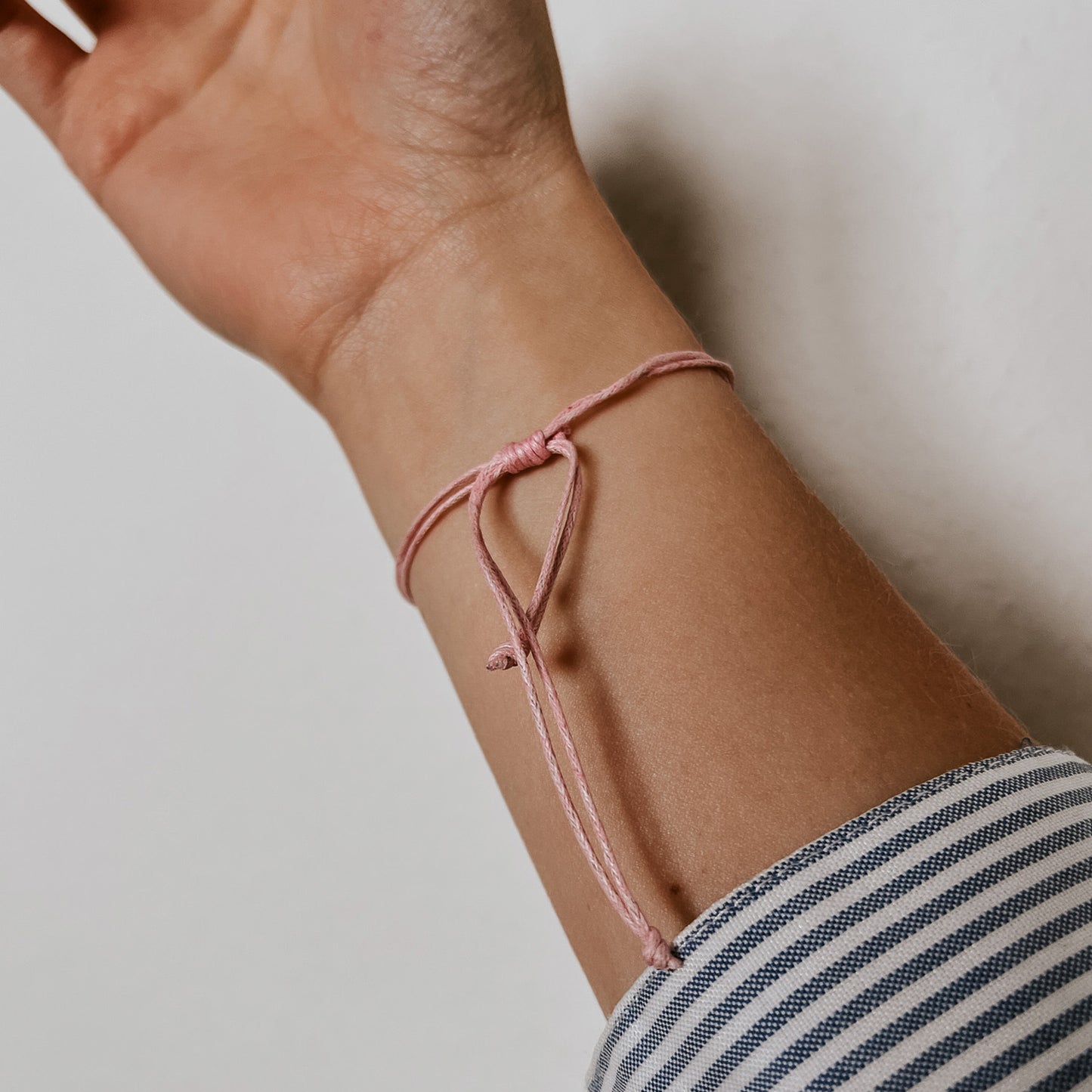 Rückansicht des zarten „Ocean“ Armbands in der Farbe rosa. Der verstellbare Verschluss sorgt für eine perfekte Passform und einen dezenten, eleganten Look am Handgelenk.
